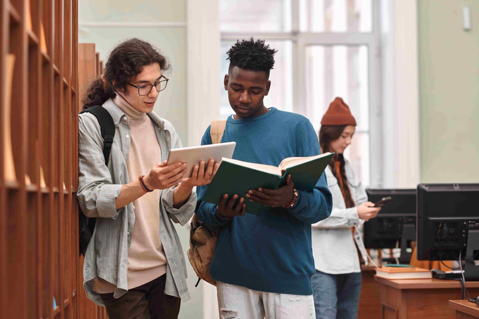 two-young-students-reading-books-standing-in-libra-2024-03-01-18-30-28-utc-compressed