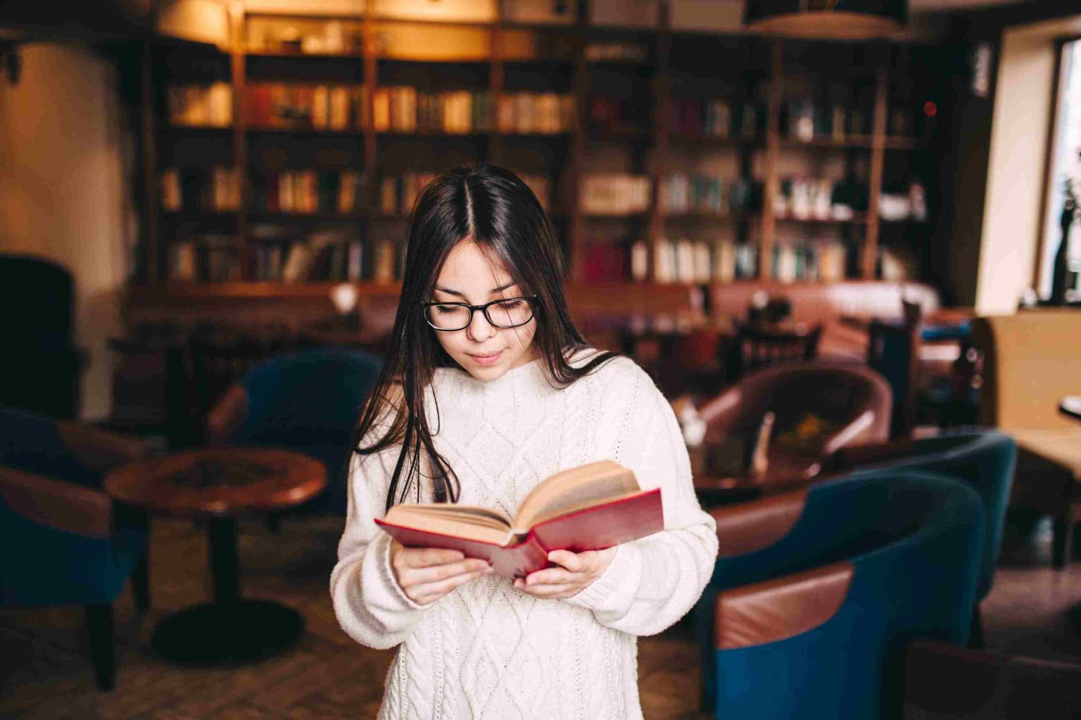 young-student-girl-reading-book-in-a-library-2023-11-27-05-07-35-utc-compressed