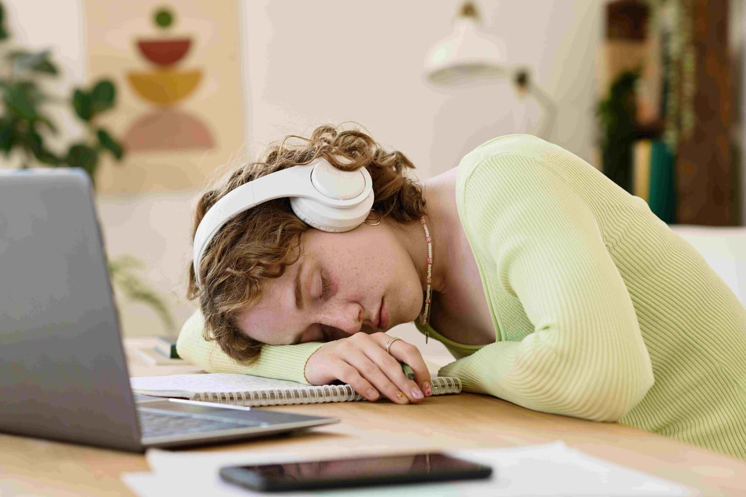 young-tired-female-student-in-headphones-keeping-h-2023-11-27-05-16-51-utc-compressed