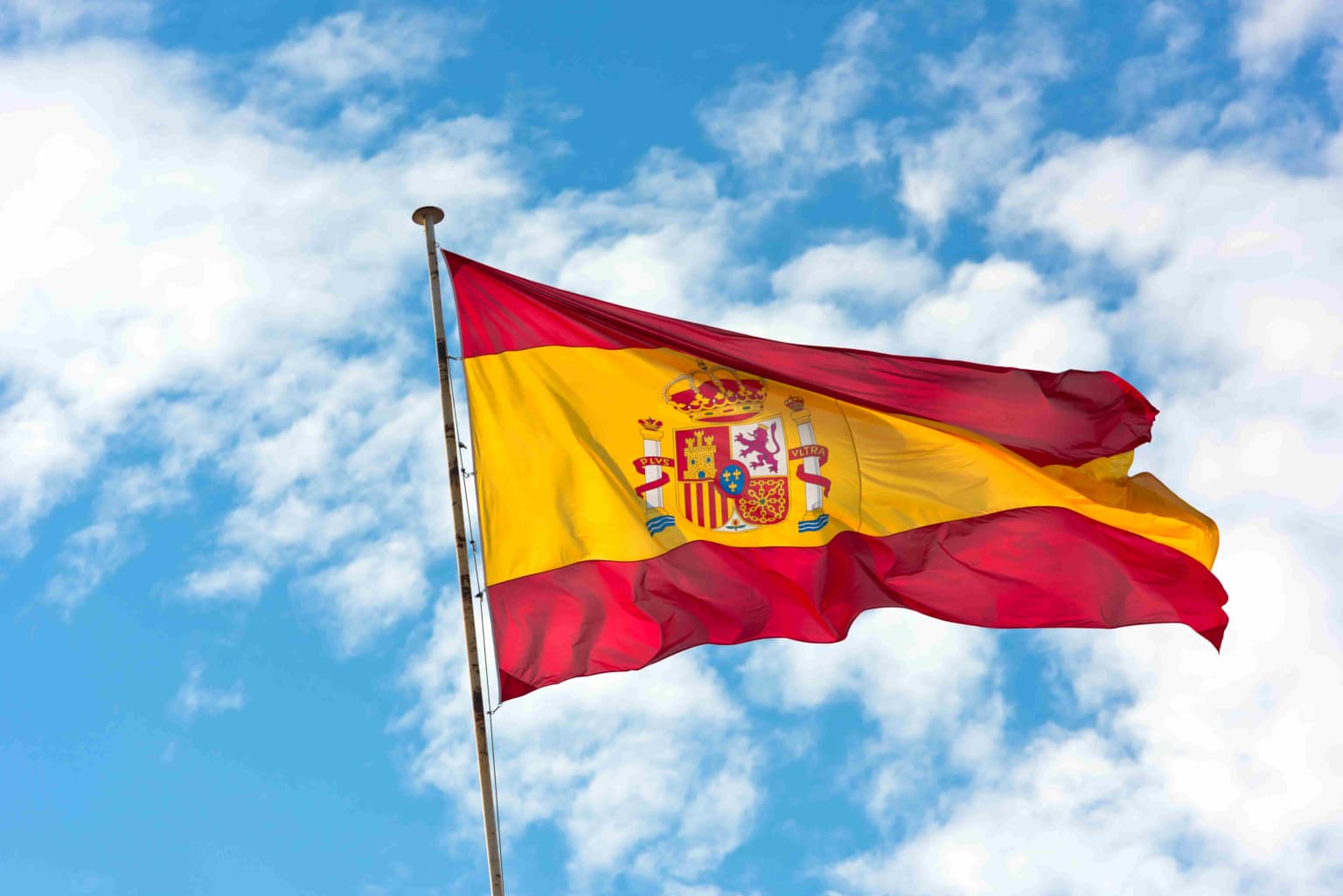 national-flag-of-spain-on-blue-sky-background-2023-11-27-05-35-51-utc-compressed