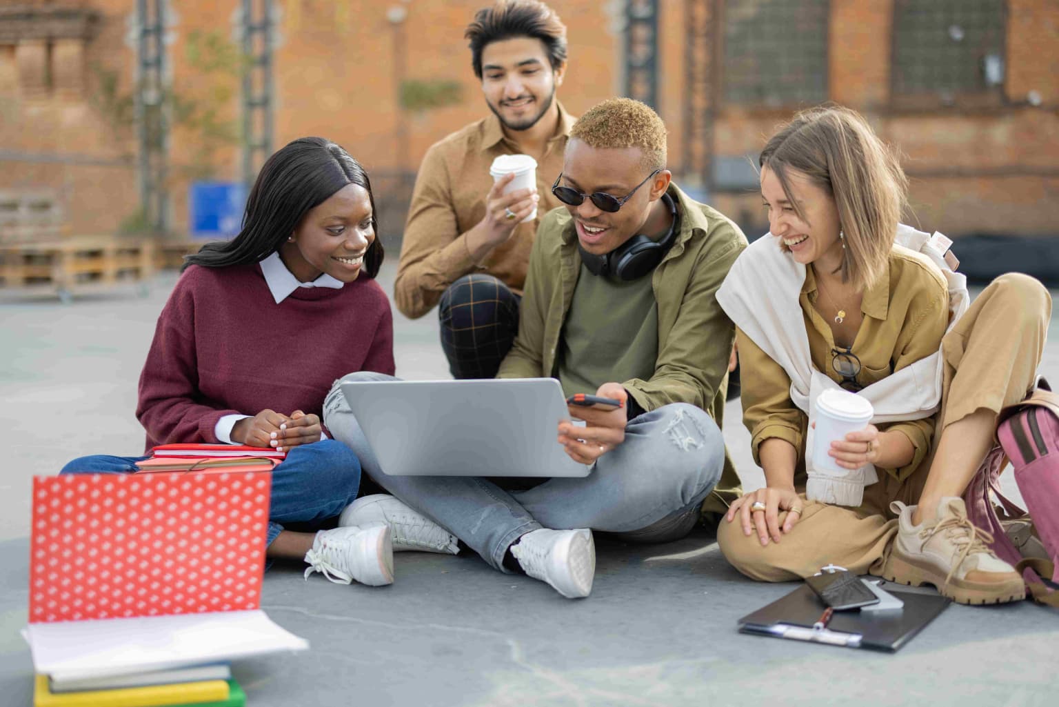 students-watching-something-on-laptop-on-asphalt-2023-11-27-05-13-43-utc-compressed