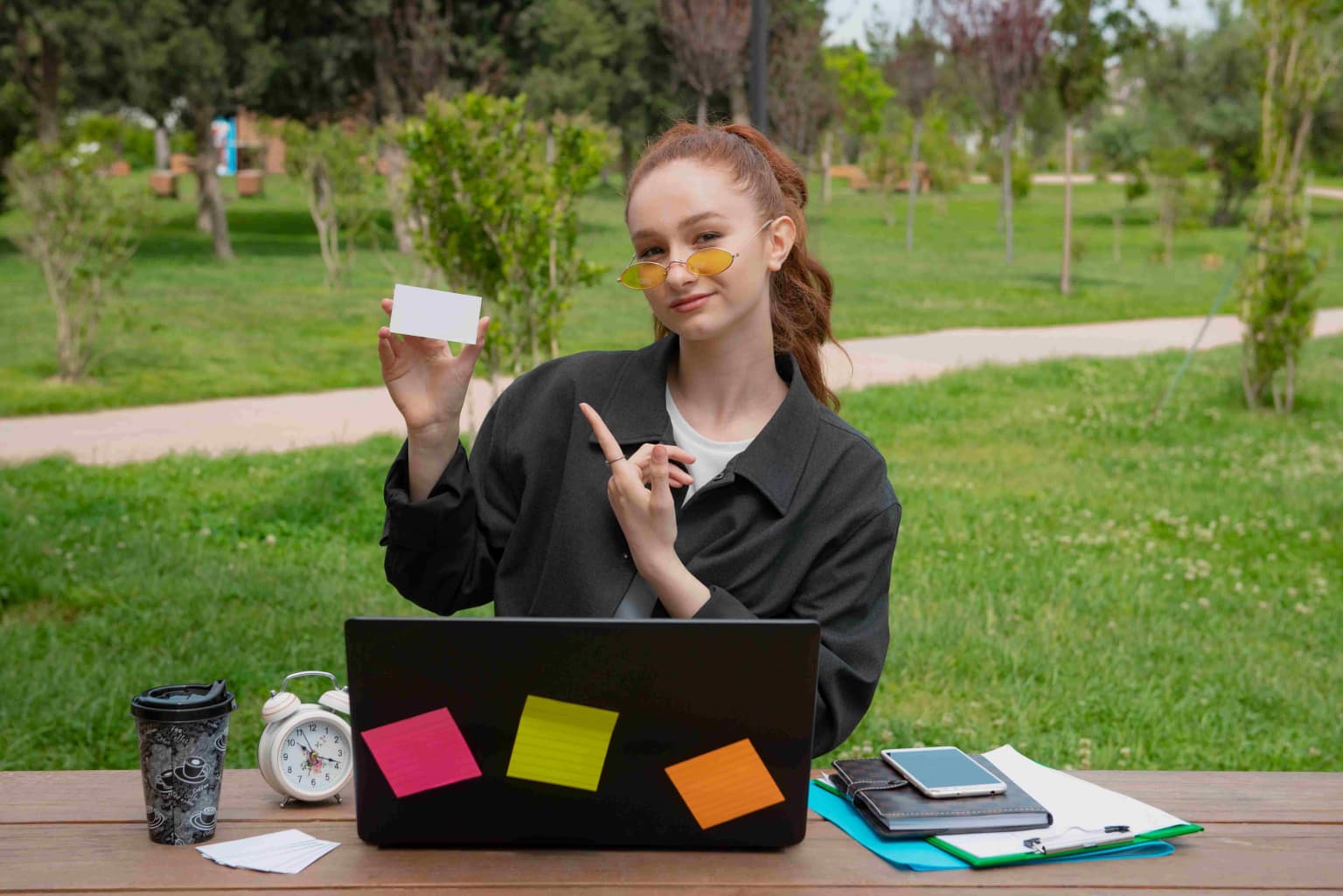 student-freelancer-sitting-holding-card-pointin-2024-08-29-18-14-44-utc-compressed