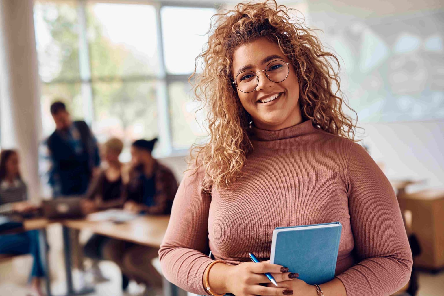 portrait-of-happy-female-student-at-college-classr-2023-11-27-04-58-34-utc-compressed